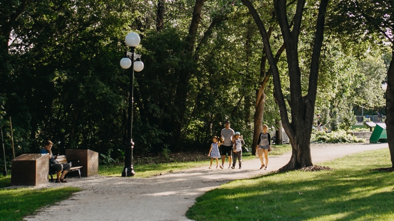 A family walking through a park pathway.