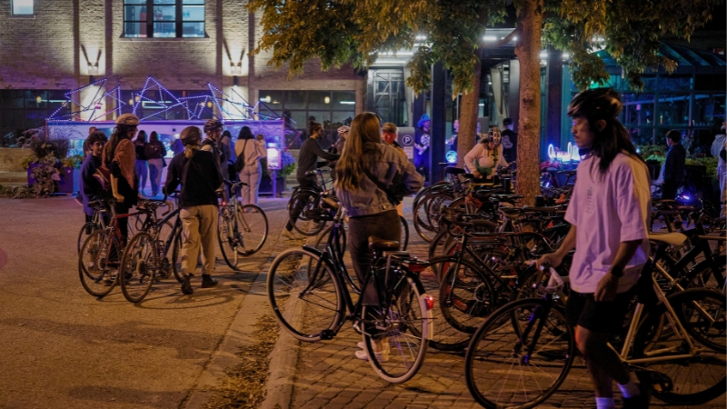 A group of cyclists at night.